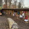 Baumstamm vor der überdachten Garderobe im Außenbereich des Kinderladens